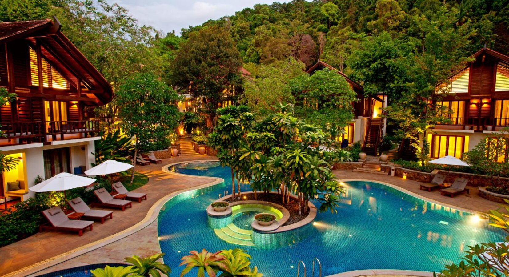 Outdoor pool surrounded by accommodation